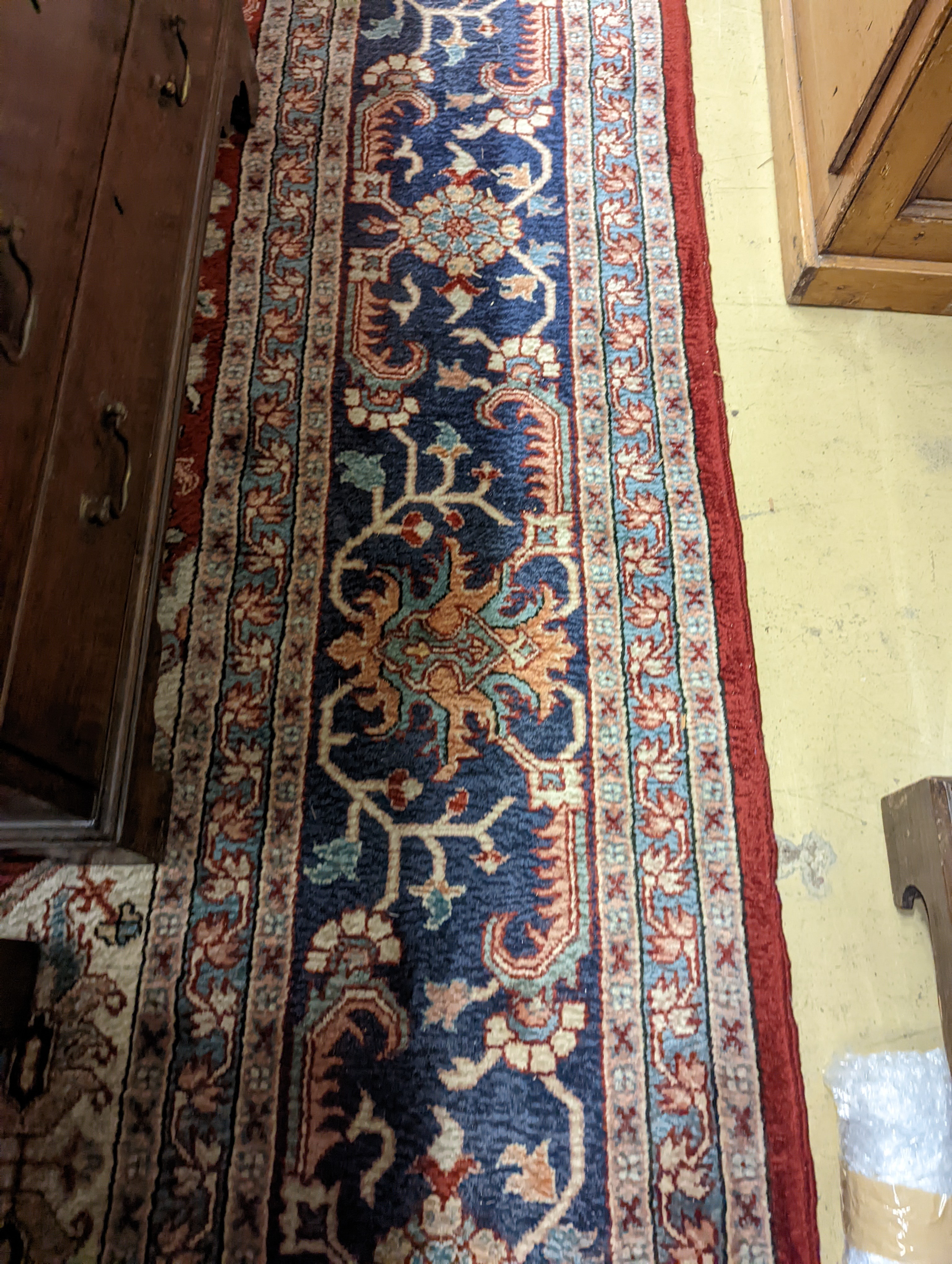 A large Caucasian style red ground carpet, 460 x 330cm